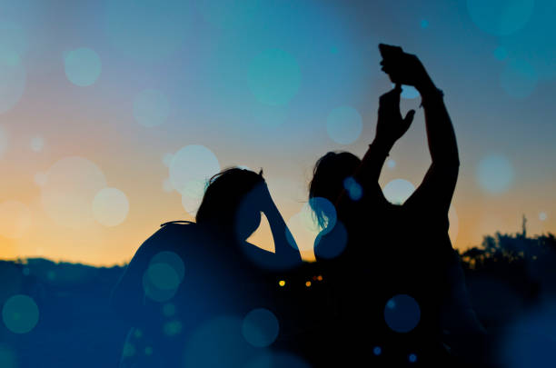 istock Friends on the beach, cell phone, connectivity, sunset 1162552792