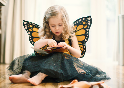 A little girl is dressed as a butterfly for Halloween