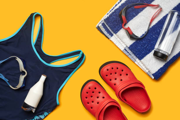 istock Flat lay summer pool accessories on a yellow background. Colorful beach wear 1162554241