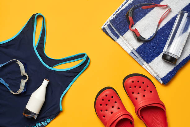 istock Flat lay summer pool accessories on a yellow background. Colorful beach wear 1162554536