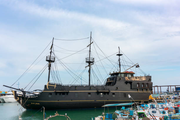 Pirate ship Black Pearl in the port of Ayia Napa, Cyprus. A copy of the ship from the movie Pirates of the Caribbean. Sea tourist walks AYIA NAPA, CYPRUS - 06.02.2018: Pirate ship Black Pearl in the port of Ayia Napa, Cyprus. A copy of the ship from the movie Pirates of the Caribbean. Sea tourist walks. pirate's cove stock pictures, royalty-free photos & images