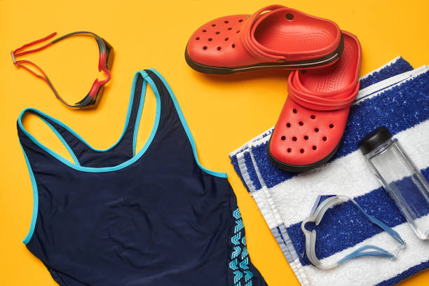 istock Flat lay summer pool accessories on a yellow background. Colorful beach wear 1162555972