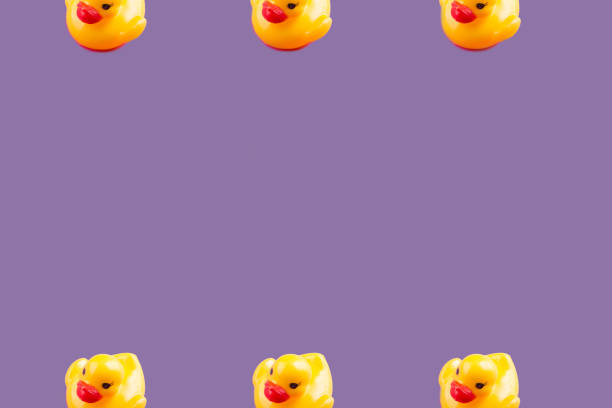 istock Yellow glamour rubber ducks pattern on purple 1162556526