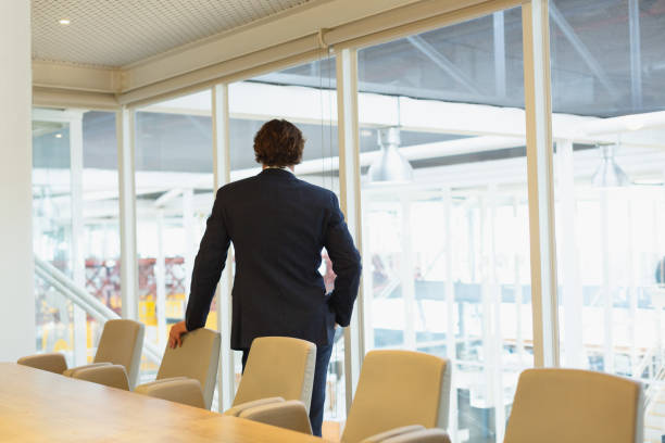 istock Thoughtful Businessman standing in the conference room at office 1162556533