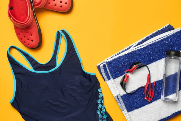 istock Flat lay summer pool accessories on a yellow background. Colorful beach wear 1162556874