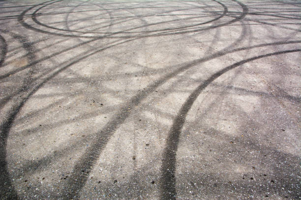 Traces of braking from rubber tyres on cement Traces of braking from rubber tyres on cement, black tire track skid mark car burnout stock pictures, royalty-free photos & images