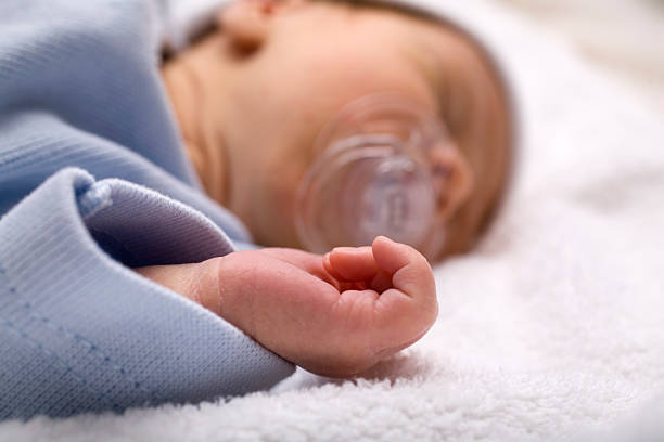 istock sleeping newborn baby with a pacifier in his mouth 116256107