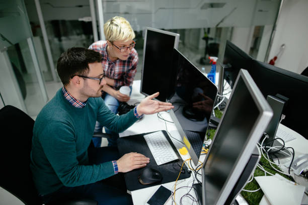 istock Two web designers working in office on a project together 1162561803