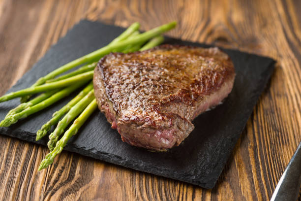 istock Meat table : grilled beef fillet with asparagus on wooden table 1162562196