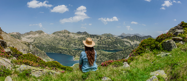 Woman with straw hat in the nature reserve Néouvielle in the Pyrenees France