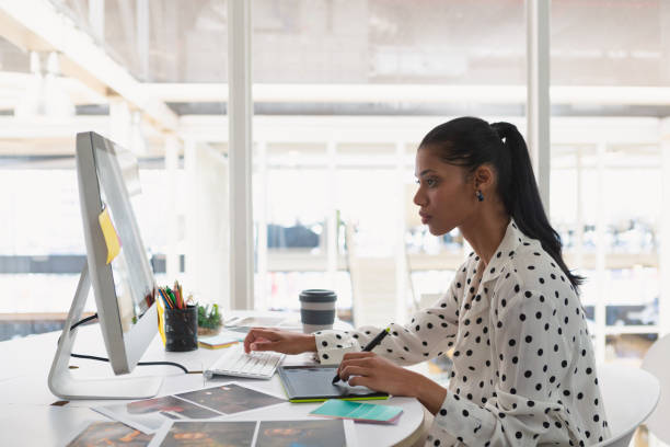 istock Female Graphic designer using graphic tablet at desk 1162564654