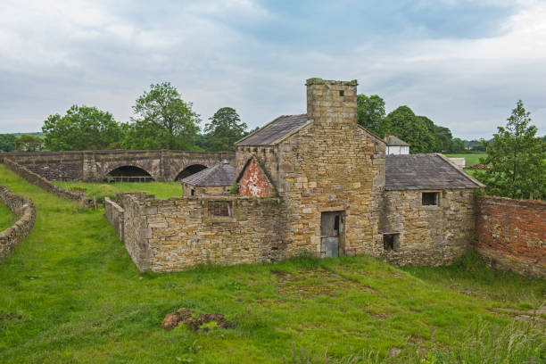 istock Old derelict mill building in rural countryside setting 1162565475