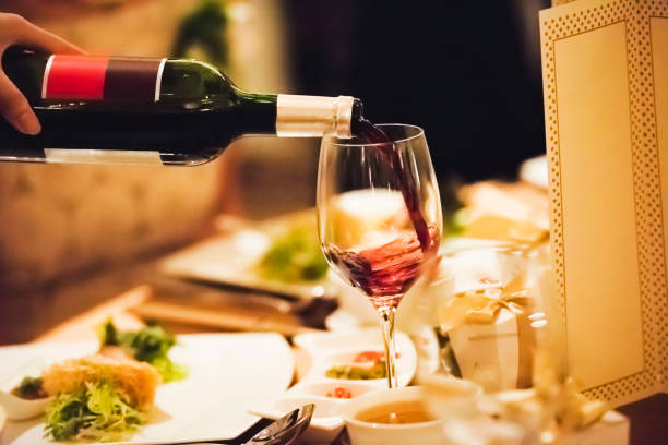istock Waiter pouring wine inside the wine glass 1162568382