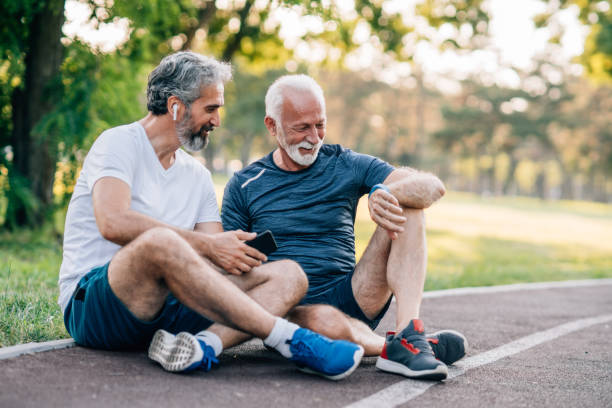 istock Smiling senior athletes relaxing after jogging in the park 1162569040