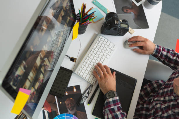 istock Male graphic designer working on computer at desk in office 1162569359