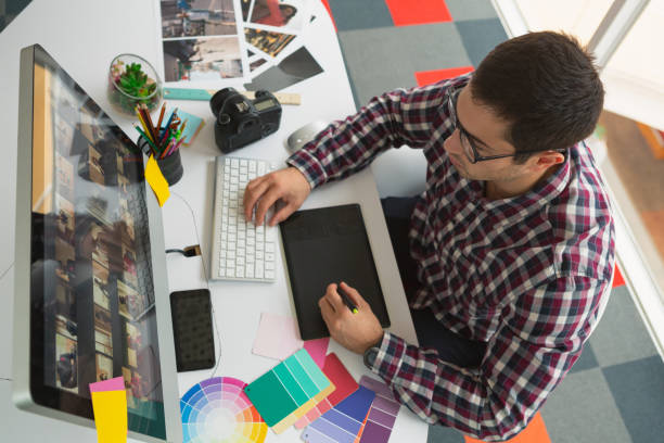 istock Male graphic designer working on computer at desk in office 1162569425
