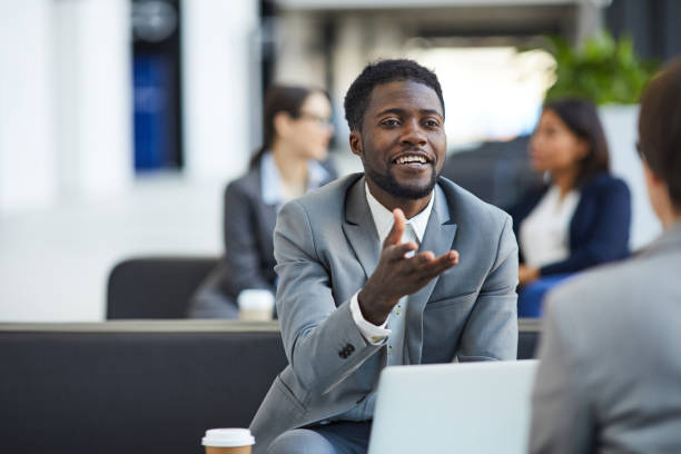 istock Black businessman meeting with partner in lobby 1162571586