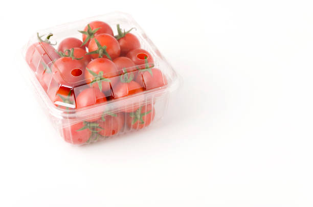 istock Cherry tomatoes in a plastic container. Fresh cherry tomatoes in box on white background. 1162571893
