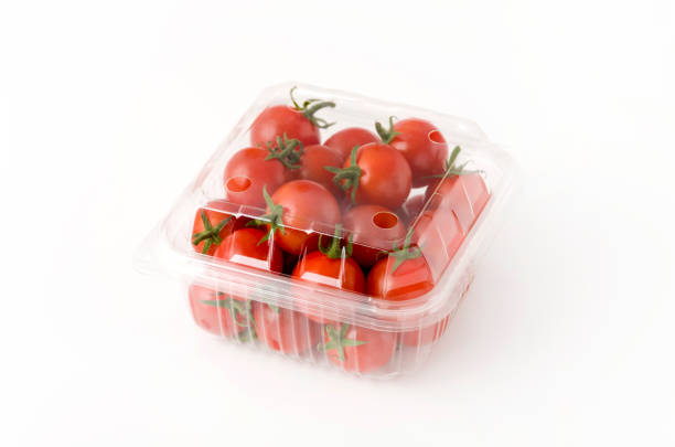 Cherry tomatoes in a plastic container. \nFresh cherry tomatoes in box on white background.