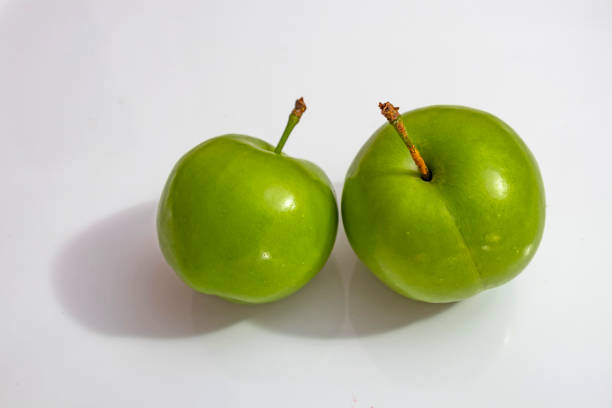 istock close up green plums in white plate 1162572301