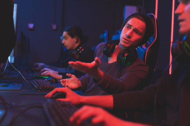istock Teen giving advice to friend about computer game 1162572785