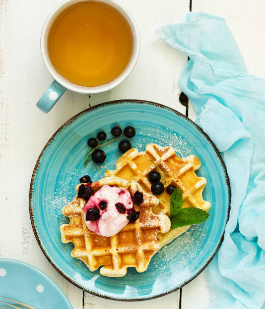 istock Homemade waffles with a sprig of currants. White background. 1162574168