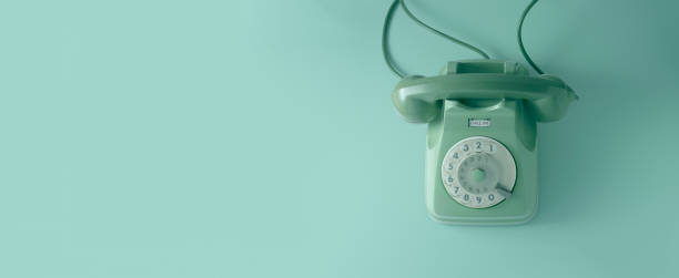 istock A vintage dial telephone with green background. 1162574546