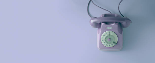 istock A vintage dial telephone with violet background. 1162574594