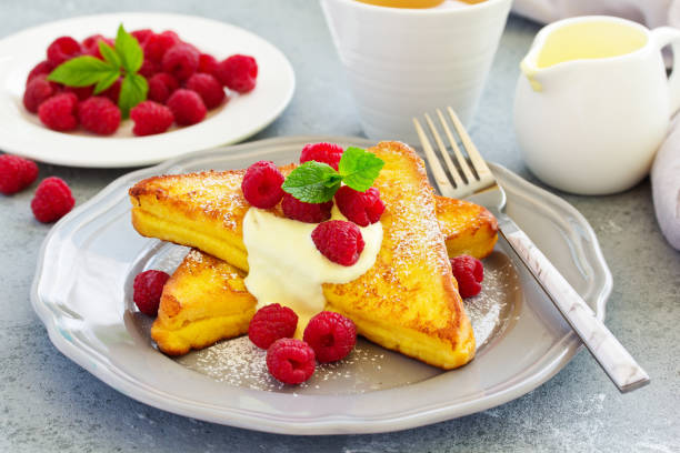 istock French toast with english sauce and raspberries. 1162576144