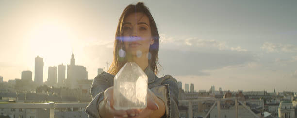 istock Crystal healing. Woman on a rooftop with city panorama 1162576178