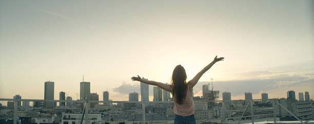 istock Young woman on a rooftop. Enjoying freedom 1162576212