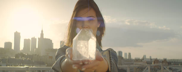 istock Crystal healing. Woman on a rooftop with city panorama 1162576241