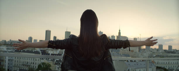 istock Young woman on a rooftop. Enjoying freedom 1162576250