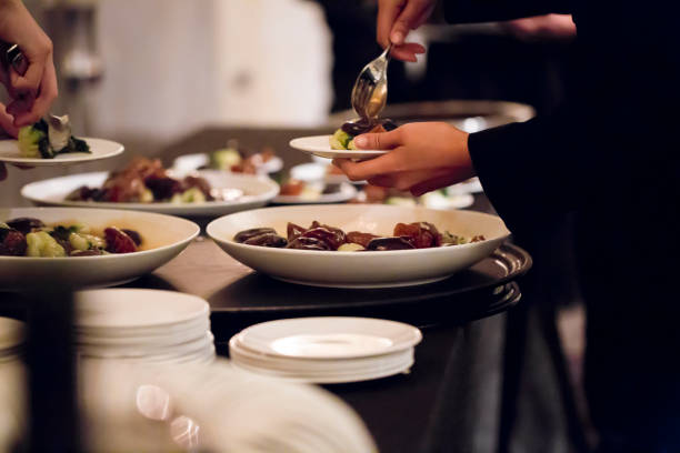 istock People putting food on plates 1162577496