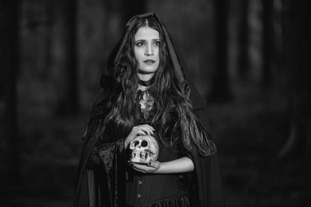 istock Portrait of a witch with a skull 1162578584