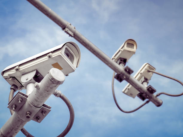 istock 3 CCTV security cameras on a high pole for public protection. 1162578758