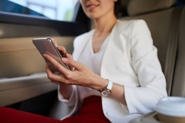 istock Woman Using Smartphone in Car 1162578993