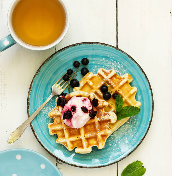 istock Homemade waffles with a sprig of currants. White background. 1162579032