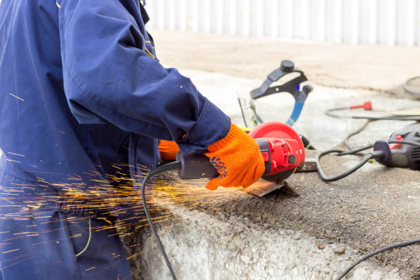 istock The worker uses an angle drive grinder to work with a metal corner. Angle drive grinder in action. 1162581455