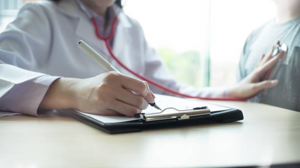 istock Cropped shot doctor consult and writing on paper. 1162582949
