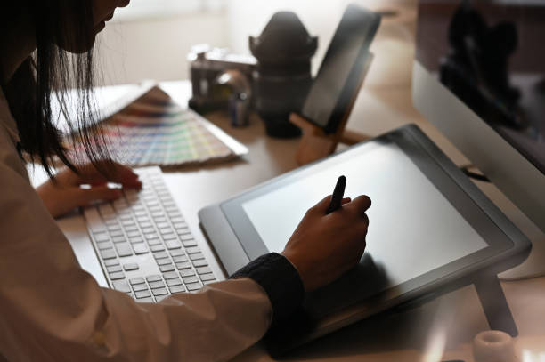 istock Young woman working with digital tablet and pen, Creative designer work on desk. 1162582980