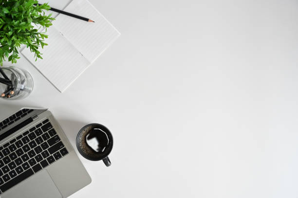 istock Top view office desk with laptop, coffee cup, pencil with notebook on copy space. 1162583081