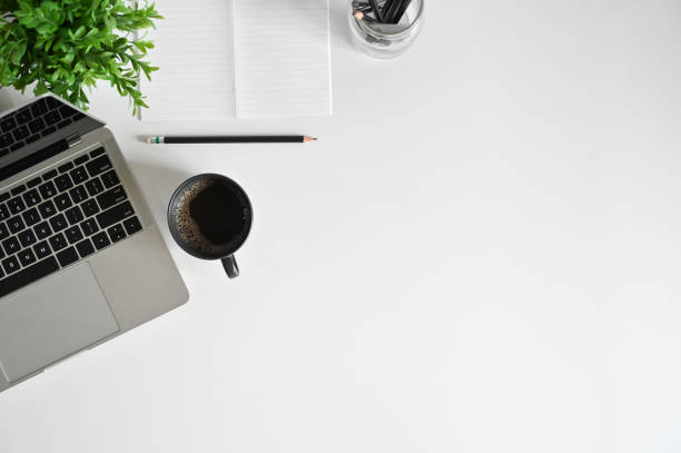 istock Top view office desk with laptop, coffee cup, pencil with notebook on copy space. 1162583116
