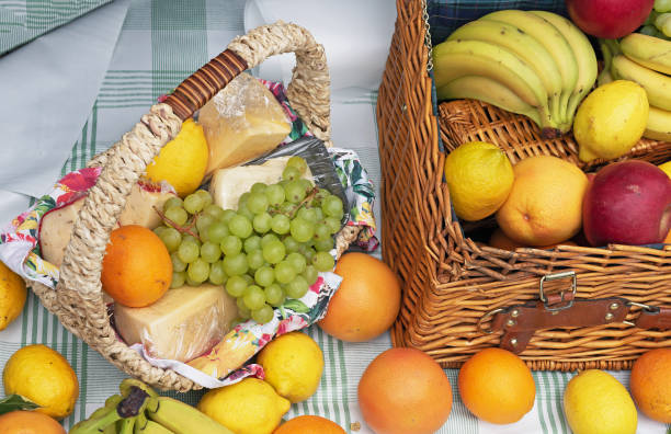 istock Ripe fruit in a wicker basket. Basket with cheese and fruit. 1162584970
