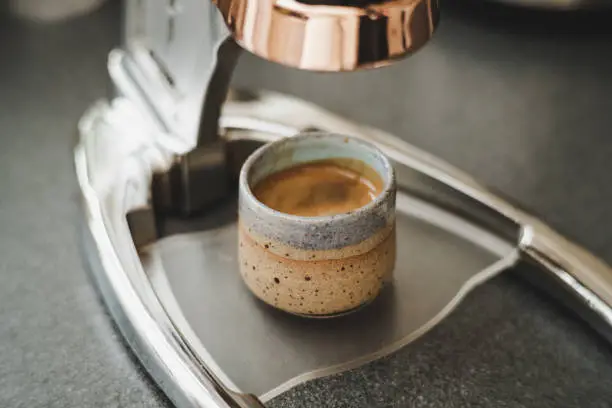 close up of fresh espresso cup on an espresso machine