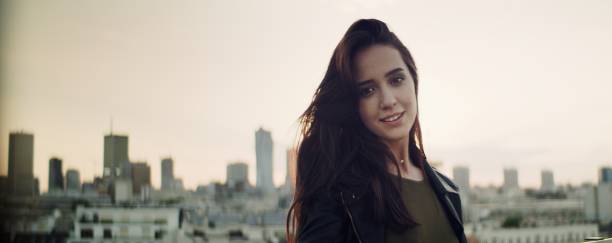 istock Young woman on a rooftop. Flirting with camera 1162587715