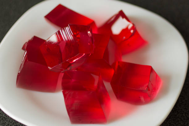 istock Red jelly cubes on white plate background. 1162587969