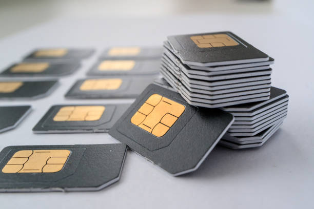 istock gray SIM card for phones collected in a column, next are cards 1162588838