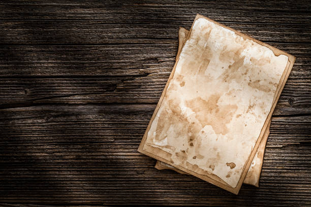 istock Old stained blank picture frames on wood background 1162588920
