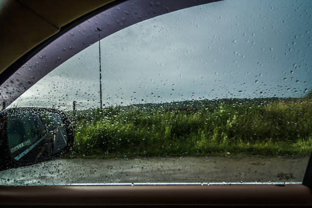 istock the car goes in the rain. view from the inside. raindrops on the windshield. Poor visibility and dangerous driving 1162589688